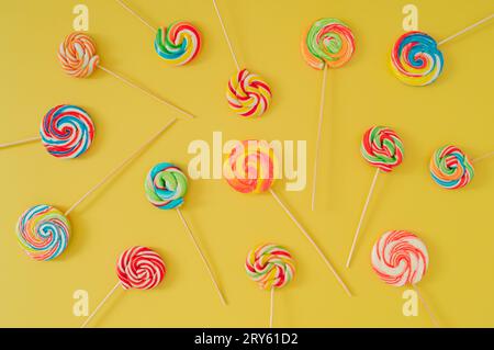 Colorful pattern made of lollipops. Flat lay fruit lollipops concept. Minimal creative composition. Candy layout idea. Stock Photo