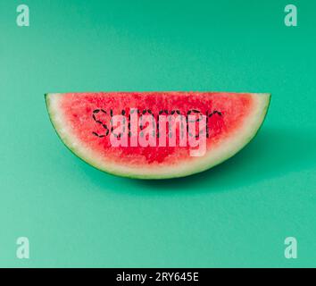 Summer watermelon layout on pastel green background. Creative minimal summer fruit concept. Trendy food arrangement. Watermelon aesthetic. Stock Photo