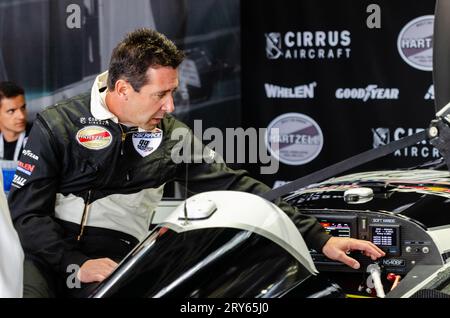 Michael Goulian, pilot, taking part in 2016 Red Bull Air Race event at Ascot Racecourse, Royal Berkshire, UK. Leaning into cockpit of Zivko Edge 540 Stock Photo