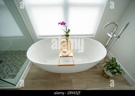 Elegant modern white freestanding bathtub with a tray Stock Photo