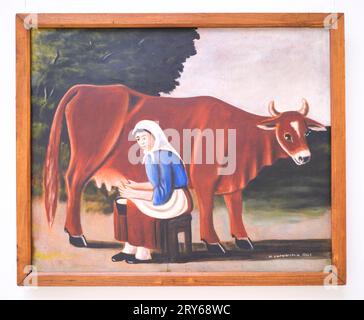 A classic, iconic painting by the artist, Niko Pirosmanashvili, titled, Woman Milking Cow. In Tbilisi, Georgia, Europe. Stock Photo