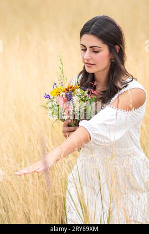 pretty woman with white dress and flowers Stock Photo