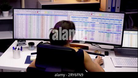 Analyst Working With Spreadsheet Business Data On Computer Stock Photo