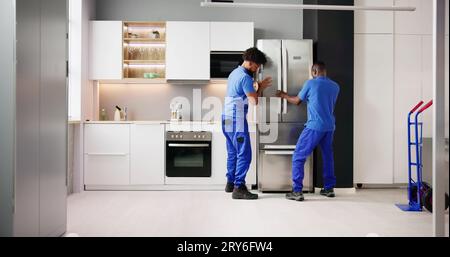 Electrician Technician Working To Repair Refrigerator Or Fridge Appliance Stock Photo
