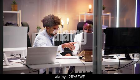Business People Training On Computer. Young Workers In Office Stock Photo