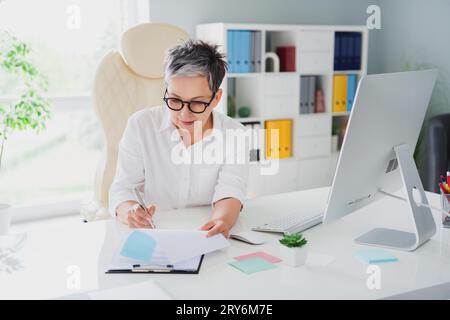 Photo attractive confident financial boss write signature documents contract important company purchase isolated indoors office background Stock Photo