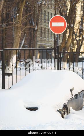 After snowstorm city traffic is halted because cars are fully buried in snow. Stock Photo