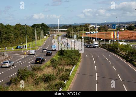 A39 by Ikea road traffic by day showing multiple lanes and new homes building site in the background, Exeter Stock Photo