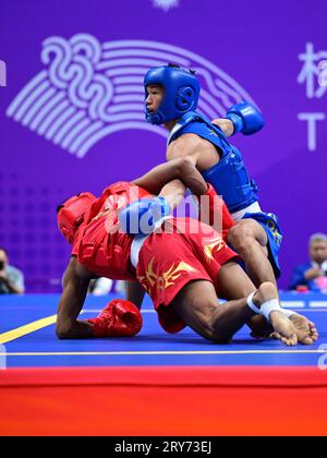 Hangzhou, China. 29th Sep, 2023. Arnel Mandal (L) of the Philippines and Jiang Haidong (R) of China compete during the Asian Games 2023, Wushu Sanda Men's 56Kg Final match at Xiaoshan Guali Sports Centre. Jiang won the match by point difference. Credit: SOPA Images Limited/Alamy Live News Stock Photo