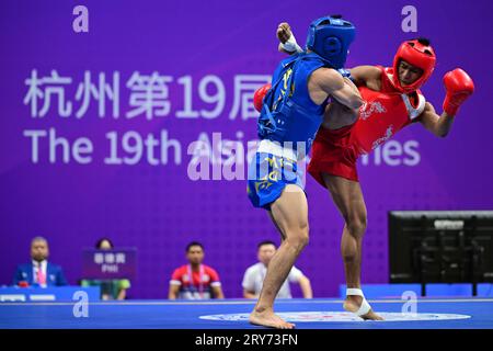 Hangzhou, China. 29th Sep, 2023. Arnel Mandal (R) of the Philippines and Jiang Haidong (L) of China compete during the Asian Games 2023, Wushu Sanda Men's 56Kg Final match at Xiaoshan Guali Sports Centre. Jiang won the match by point difference. Credit: SOPA Images Limited/Alamy Live News Stock Photo