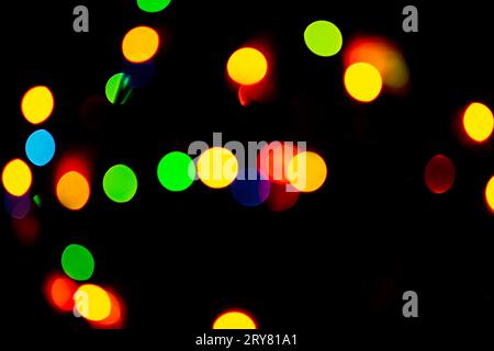 Neon light rays flash and glow on black. Light streaks electric color on black background. Stock Photo
