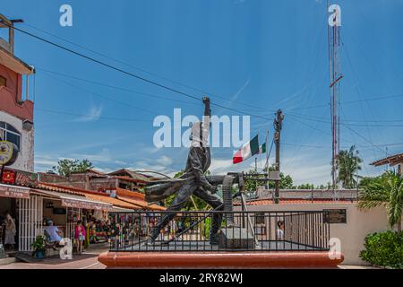 Zihuatanejo, Mexico - July 18, 2023: Side view on Bronze Jose Azueta Abad statue in front of shopping street, Mexican Navy war hero during US occupati Stock Photo