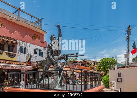 Zihuatanejo, Mexico - July 18, 2023: Corner closeup on Bronze Jose Azueta Abad statue in front of shopping street, Mexican Navy war hero during US occ Stock Photo