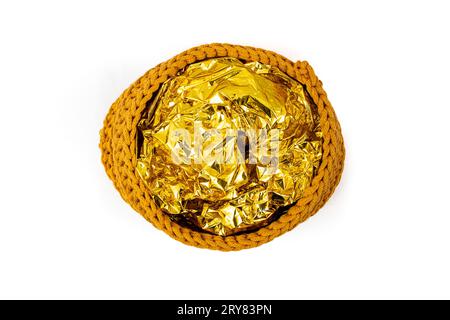 Golden tin foil on a rope crochet basket, isolated on white, abstract backdrop Stock Photo