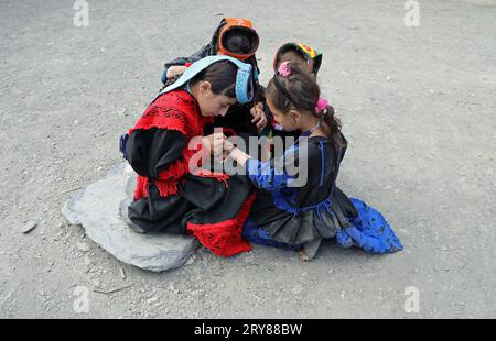 Kalash girls painting their hands with henna in preparation for the summer festival of Uchal Stock Photo