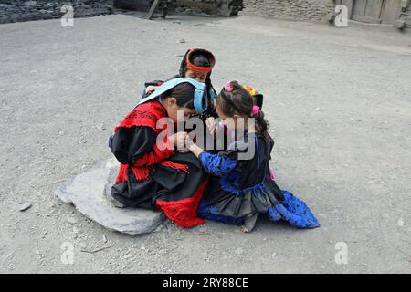 Kalash girls painting their hands with henna in preparation for the summer festival of Uchal Stock Photo