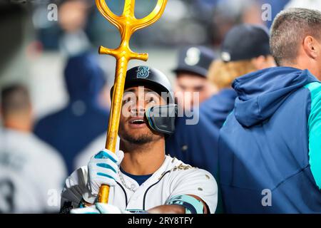 Seattle Mariners' Julio Rodríguez holds a trident in the dugout after  hitting a home run in a baseball game against the Texas Rangers, Thursday,  Sept. 28, 2023, in Seattle. (AP Photo/Lindsey Wasson
