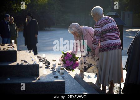 Kyiv, Ukraine. 29th Sep, 2023. Former ghetto prisoners, and survivors of Nazi concentration camps, place flowers on the Menorah memorial during a remembrance event on the 82nd anniversary of the Babyn Yar massacre at the National Historical Memorial Preserve Babyn Yar, September 29, 2023 in Kyiv, Ukraine. Nazi occupiers massacred between 100,000 and 150,000 civilians at the site during World War II. Credit: Ukraine Presidency/Ukrainian Presidential Press Office/Alamy Live News Stock Photo