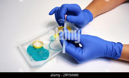 Injection of spinal anesthesia in preparation for surgery. The hands of ...