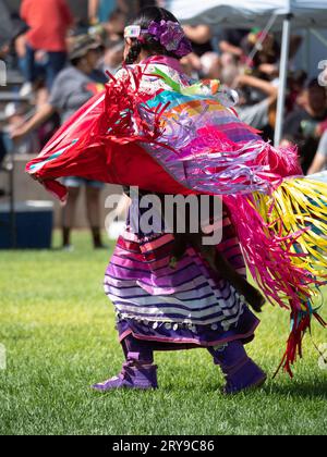 Little Girl in Ribbon Dress dancing at the Little Shell Chippewa Pow Wow in Great Falls, Montana Stock Photo