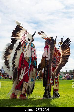 Two Native American Men in Full Regalia talking at the Little Shell Chippewa Pow Wow in Great Falls, Montana. Photographed from a low-angle view. Stock Photo