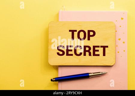 Open yellow envelope with top secret stamp and blank papers, on wooden table, clipping path Stock Photo