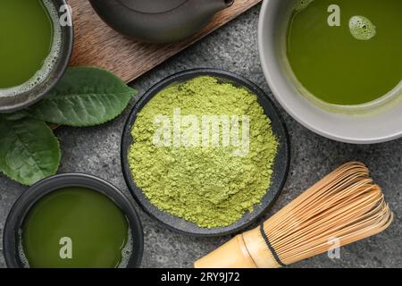 Flat lay composition with green matcha powder and fresh beverage on grey table Stock Photo