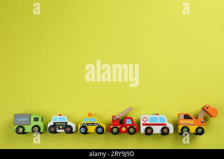 Different toy cars for children on yellow background, flat lay. Space for text Stock Photo