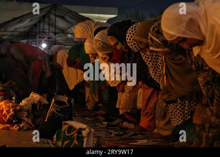 September 29, 2023, Srinagar Kashmir, India : Kashmiri Muslim women offer prayers during Mawlid-un-Nabi or Prophet Muhammad's (PBUH) birth anniversary in Dargah Hazratbal shrine in Srinagar. Hundreds of thousands of Muslims from all over Kashmir visit the Hazratbal shrine in Srinagar to pay obeisance on the birth anniversary of Prophet Mohammed (PBUH) . The shrine is highly revered by Kashmiri Muslims as it is believed to house a holy relic of the Prophet Mohammed (PBUH). The relic is displayed to the devotees on important Islamic days such as the Mawlid-un-Nabi when Muslims worldwide celebrat Stock Photo