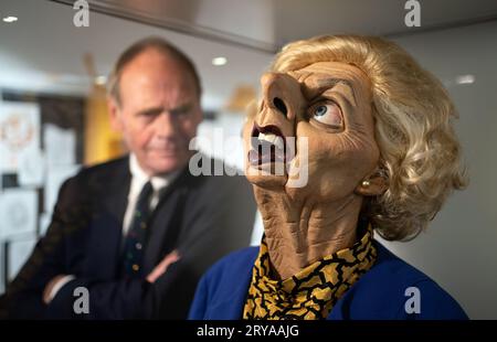 Spitting Image producer John Lloyd with a puppet of former Prime Minister Margaret Thatcher during the preview for the Spitting Image exhibition at Cambridge University Library. The entire archive of satirical TV show Spitting Image has been donated to Cambridge University Library under the government's Cultural Gifts Scheme. Puppets from the programme, including of Margaret Thatcher, Princess Diana and the Queen Mother, are among the items to go on display in a free exhibition from Saturday. Picture date: Thursday September 28, 2023. Stock Photo