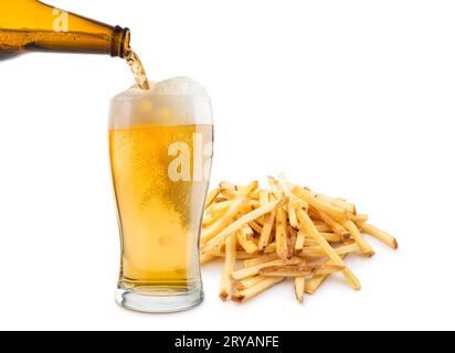Glass of blonde beer with french fries on white background. Stock Photo