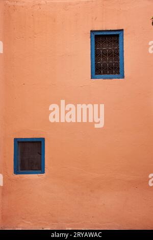 blue frames windows on terracotta building in Morocco March 2012 Stock Photo