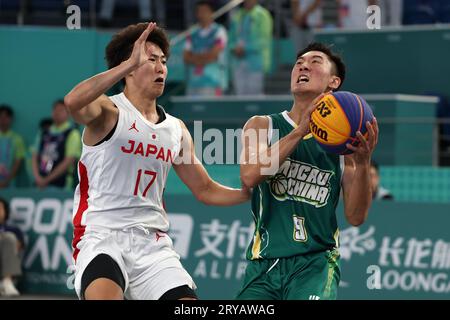 Huzhou, China's Zhejiang Province. 30th Sep, 2023. Nip Chio Wa (R) of China's Macao competes during Men's Qualifications to Quarterfinal of 3X3 Basketball between Japan and China's Macao at the 19th Asian Games in Huzhou, east China's Zhejiang Province, Sept. 30, 2023. Credit: Chen Bin/Xinhua/Alamy Live News Stock Photo