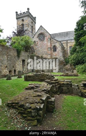 Ruins of Culross Abbey’s 13th century cloisters in the foreground. The remaining intact part of the structure serves as the local parish church. Stock Photo