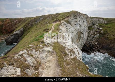 On top of the rock arch 'Bwa Gwyn' on the coast near Rhoscolyn, Anglesey, North Wales. Stock Photo