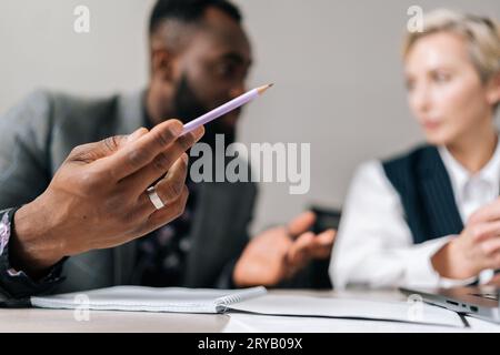 Selective focus view of female manager insurer consulting black male customer with laptop at meeting. Mature woman mentor showing presentation Stock Photo
