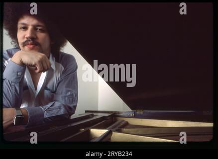 A 1983 posed portrait of jazz pianist composer Anthony Davis near his piano. In his home in Manhattan, New York City. Stock Photo