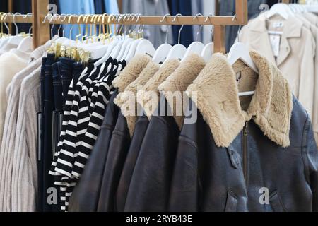 Men's fur leather jackets and other clothing in the clothing store Stock Photo