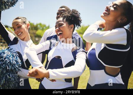 Cheerleaders, field and team with celebration, game and winner with happiness, motivation and smile. Women, men and group cheering, outdoor or Stock Photo