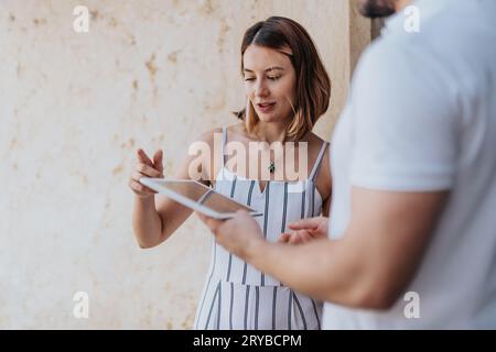 Two people, woman and man, partners, discuss data trends, e-commerce strategies, and online retail. They work as a team to maximize sales and target t Stock Photo