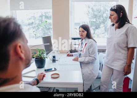 A busy hospital clinic with doctors conducting thorough examinations, checking eyesight, hearing, and throat, cleaning ears, and providing successful Stock Photo