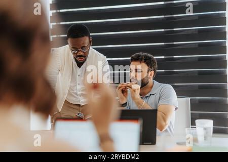 Concentrated multiracial colleagues working on project together at the office. Teamwork concept. Stock Photo