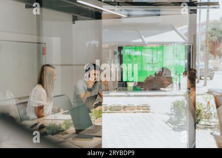 A diverse business team discussing analytic, profit growth, and project development in an indoor office workspace. Stock Photo