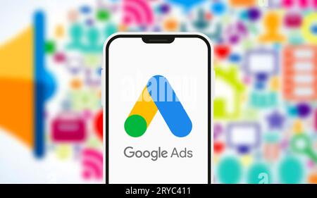 A high-detail close-up of a smartphone screen displaying the Google Ads logo and campaign management interface. This editorial image illustrates the d Stock Photo