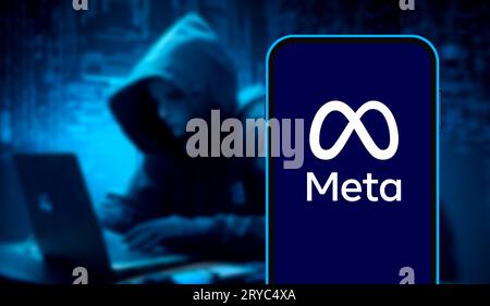A high-detail close-up of a smartphone screen displaying the blue infinity-shaped logo of Meta Platforms, Inc. This editorial image represents the evo Stock Photo