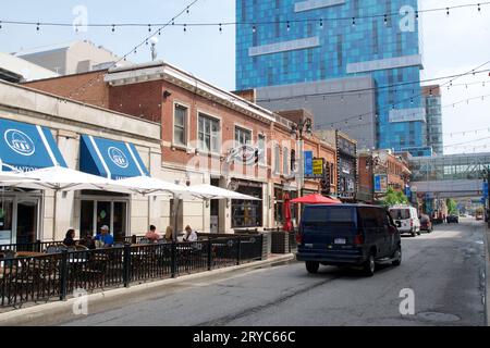 DETROIT, MICHIGAN, UNITED STATES - May 22, 2018: Street in the Greektown district of Detroit with restaurants in historic buildings and a skyscraper Stock Photo