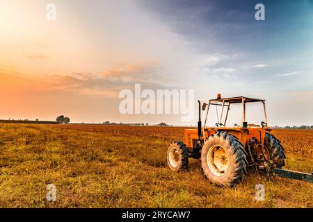 Tractor and harvested land Stock Photo