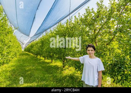 Teenager next to apple trees Stock Photo