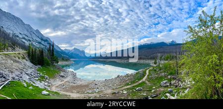 A panorama of the beautiful Edith Lake along Maligne Road in Jasper National Park in Canada on a beautiful spring day. Stock Photo