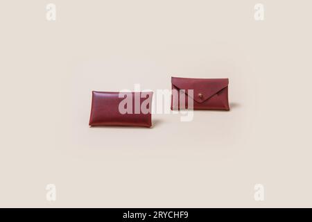 Brown leather wallet are lined up  isolated on beige background, front view Stock Photo